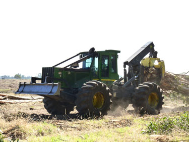 Fig 3 Four wheel drive skidder snigging whole trees to a landing site 